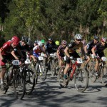 Mens Expert riders pounce on the pedals at the starting line.